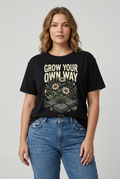 Model mockup wearing a black Grow Your Own Way floral graphic T-shirt